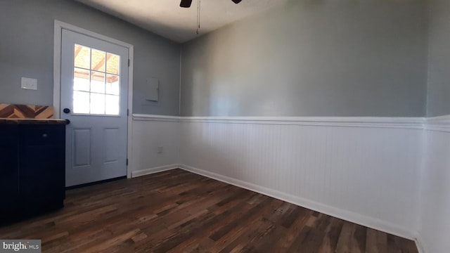 doorway with dark hardwood / wood-style flooring and ceiling fan