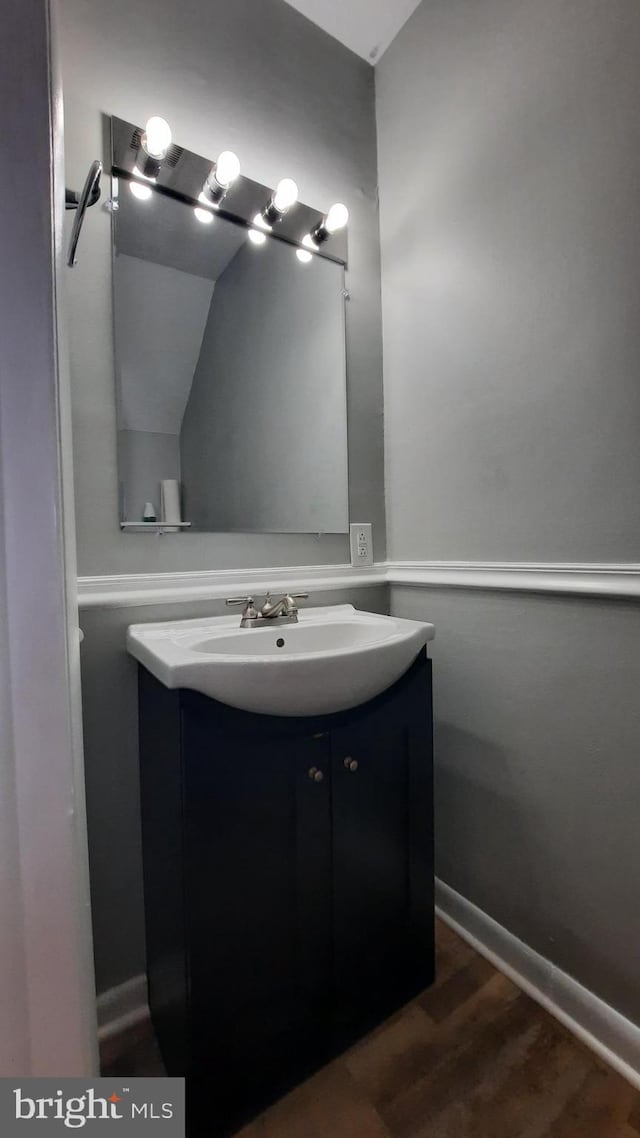 bathroom with vanity and wood-type flooring