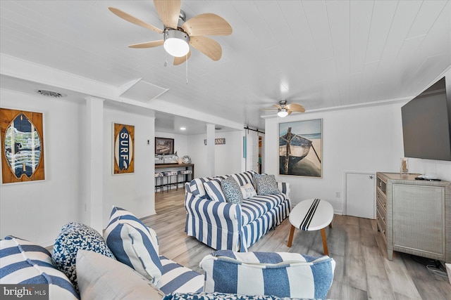 living room featuring light hardwood / wood-style flooring and ceiling fan