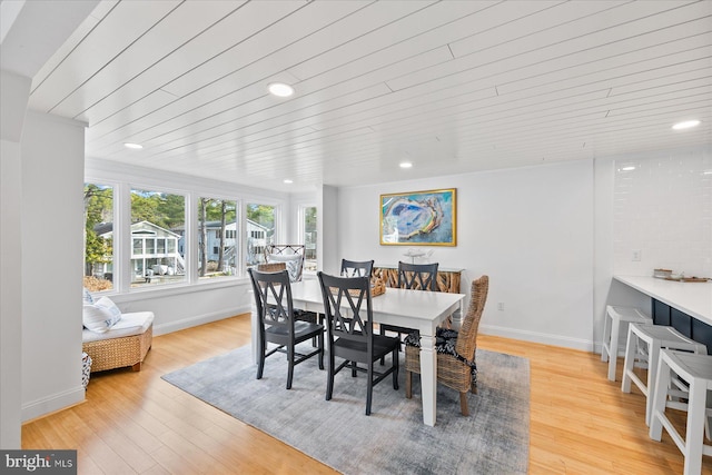 dining room featuring wood ceiling and light hardwood / wood-style flooring