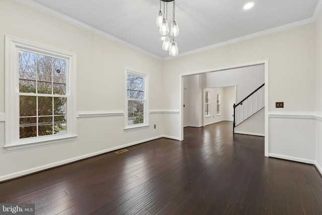 unfurnished dining area featuring ornamental molding and dark hardwood / wood-style flooring