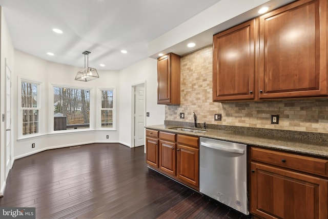 kitchen featuring decorative light fixtures, dishwasher, sink, dark hardwood / wood-style flooring, and decorative backsplash