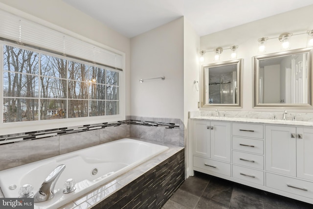 bathroom with vanity and a relaxing tiled tub