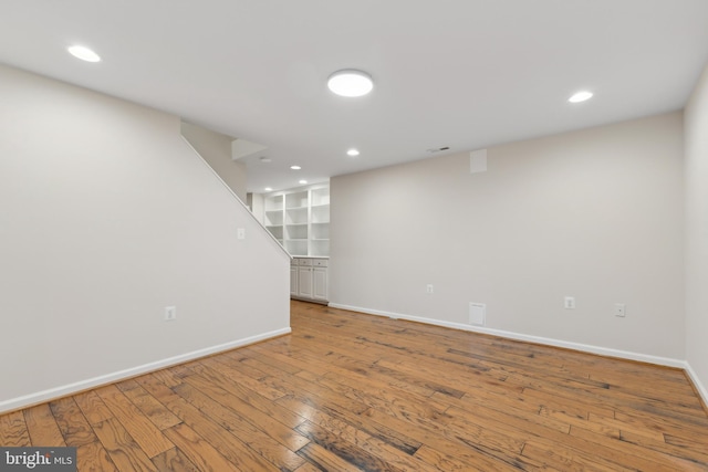 basement with hardwood / wood-style floors