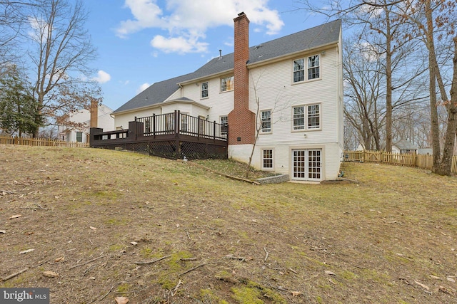 back of property featuring a yard, french doors, and a deck