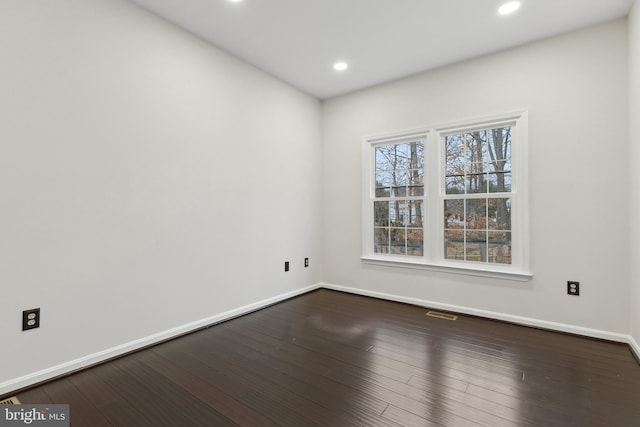 spare room featuring wood-type flooring