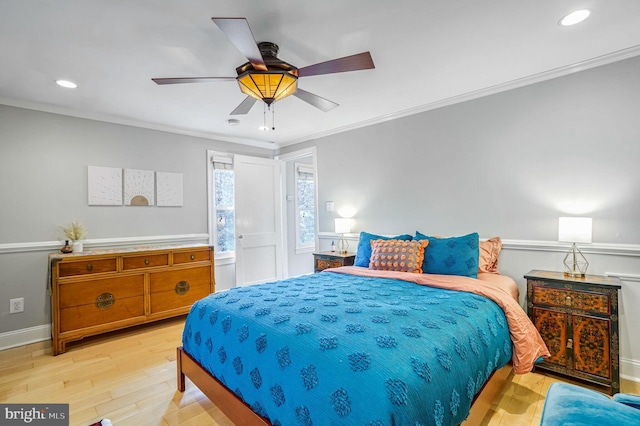 bedroom with crown molding, ceiling fan, and light wood-type flooring