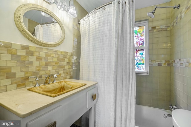 full bathroom with vanity, a healthy amount of sunlight, shower / bath combination with curtain, and toilet