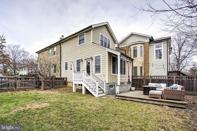 back of house featuring a wooden deck, a yard, and an outdoor hangout area