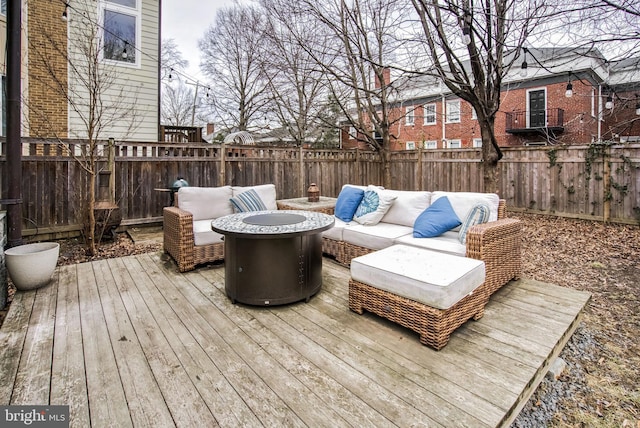 wooden deck with an outdoor living space with a fire pit