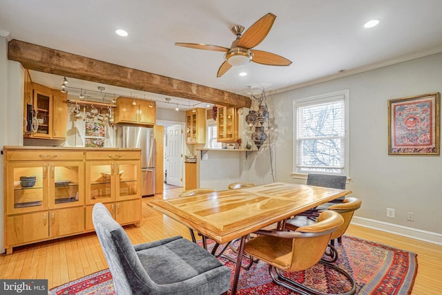 dining space featuring ornamental molding, track lighting, ceiling fan, and light hardwood / wood-style floors