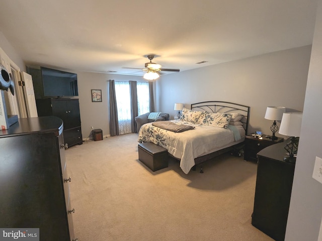 bedroom featuring a ceiling fan, light colored carpet, and visible vents