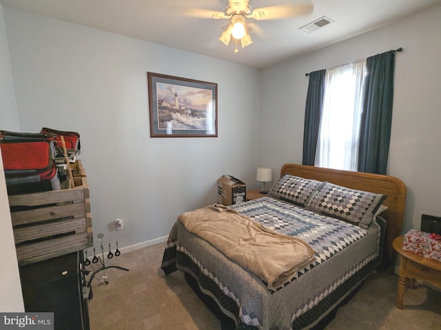 bedroom featuring carpet floors, visible vents, baseboards, and a ceiling fan