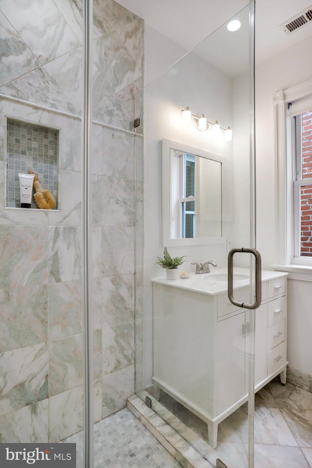 bathroom featuring an enclosed shower and vanity