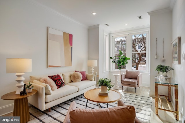 living room with ornamental molding and light hardwood / wood-style flooring