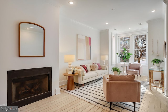 living room featuring light wood-type flooring and ornamental molding