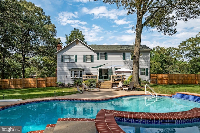 view of pool with a patio and a yard