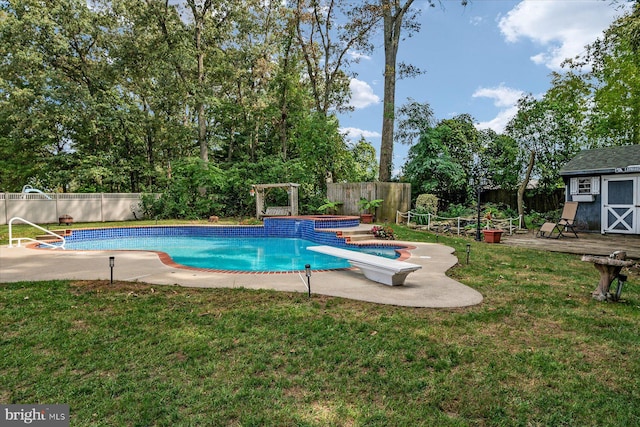 view of pool featuring a hot tub, a diving board, a lawn, and a storage shed