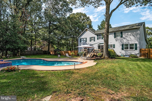 view of pool featuring a diving board and a lawn