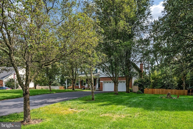 view of front of home featuring a garage and a front lawn