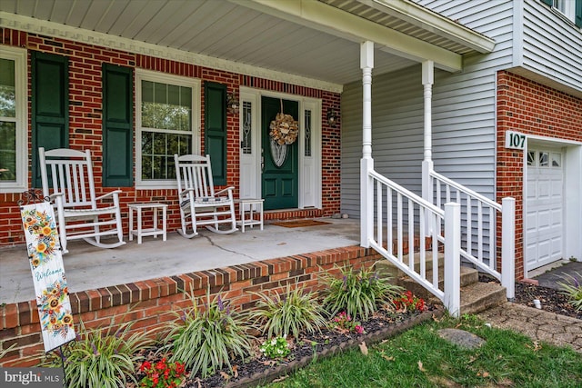 entrance to property with a porch and a garage