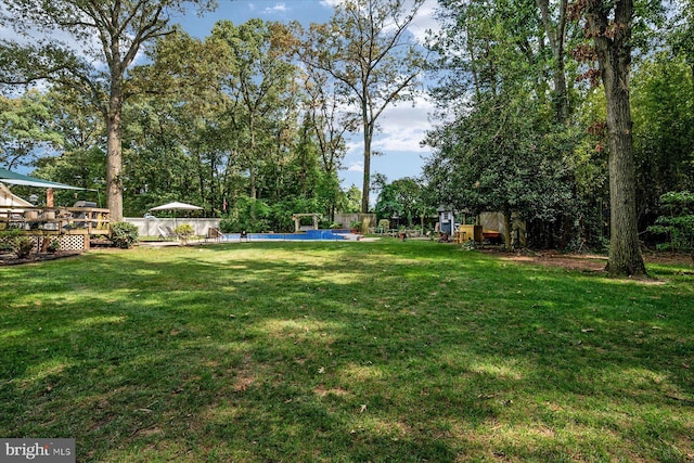 view of yard featuring a swimming pool side deck