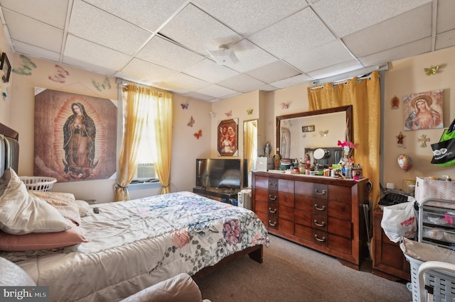 carpeted bedroom with a paneled ceiling