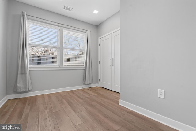 unfurnished room with light wood-type flooring