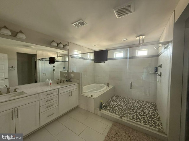 bathroom with plus walk in shower, vanity, and tile patterned floors