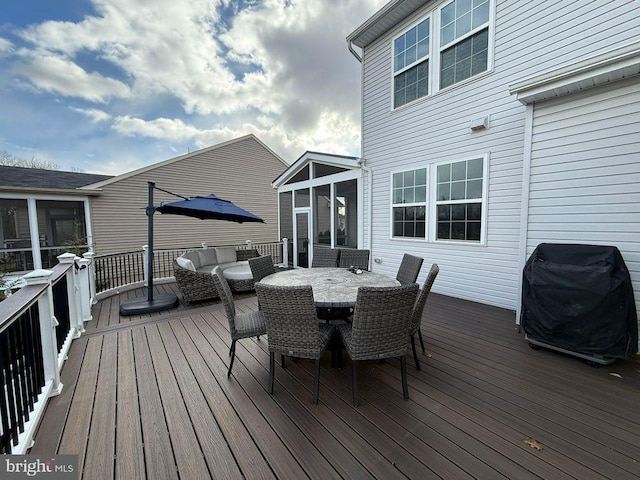 wooden terrace featuring a sunroom, area for grilling, and an outdoor hangout area