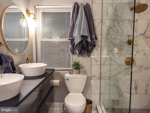 bathroom featuring vanity, toilet, and a tile shower