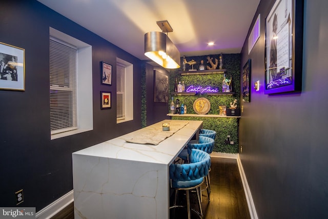 bar featuring dark wood-type flooring