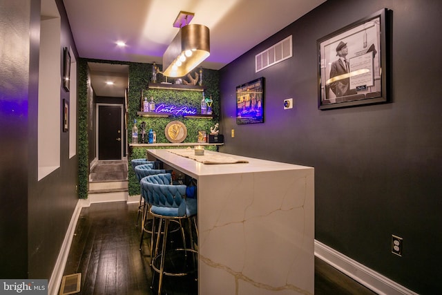 bar featuring dark hardwood / wood-style floors