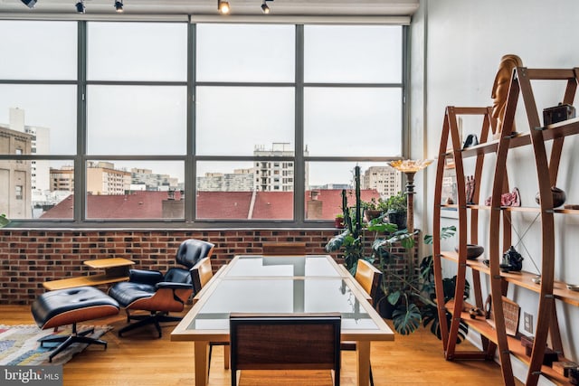 interior space featuring light hardwood / wood-style flooring and brick wall