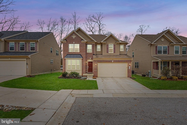 view of front of property featuring a garage and a lawn