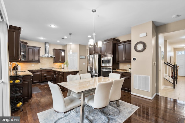 dining area with dark hardwood / wood-style flooring and sink