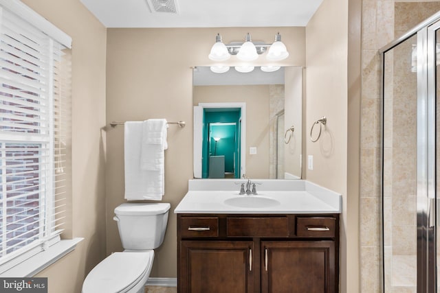 bathroom with vanity, toilet, and walk in shower