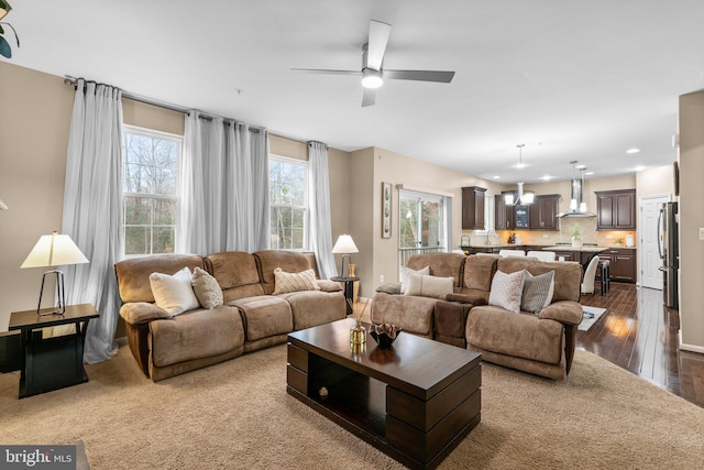 living room featuring hardwood / wood-style flooring and ceiling fan