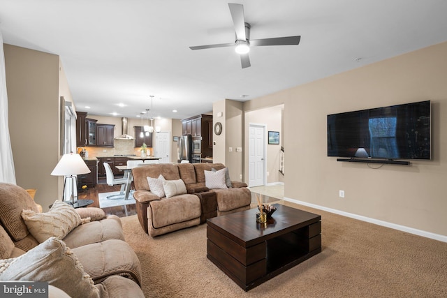 living room featuring carpet floors and ceiling fan