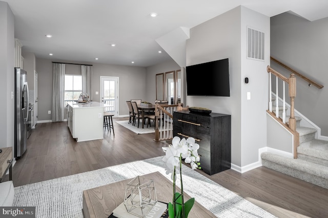 living room with dark hardwood / wood-style flooring