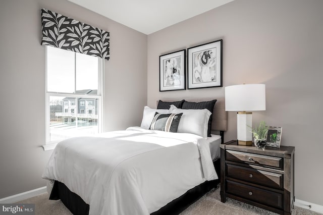 carpeted bedroom featuring multiple windows