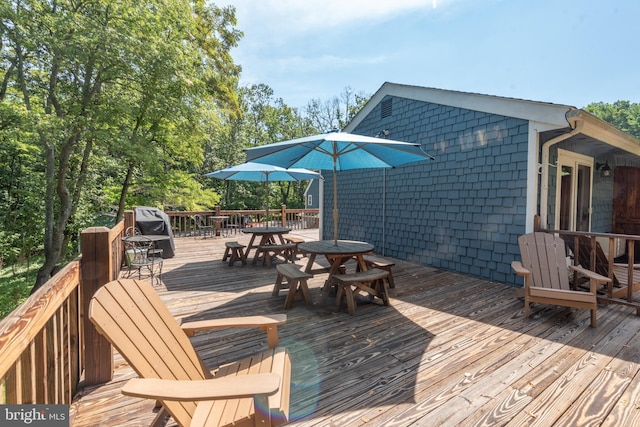 deck featuring outdoor dining area