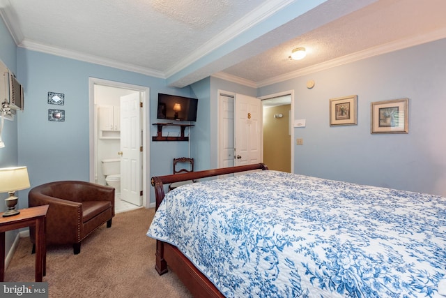 bedroom with carpet floors, ornamental molding, a textured ceiling, and ensuite bath
