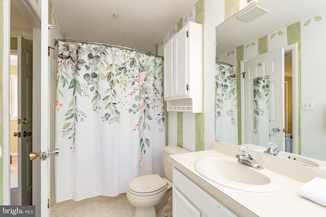 bathroom with wallpapered walls, vanity, toilet, a textured ceiling, and tile patterned floors