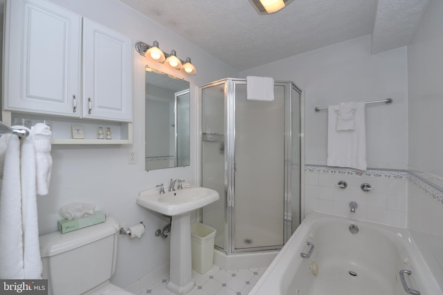 full bathroom with a stall shower, a garden tub, a textured ceiling, and toilet