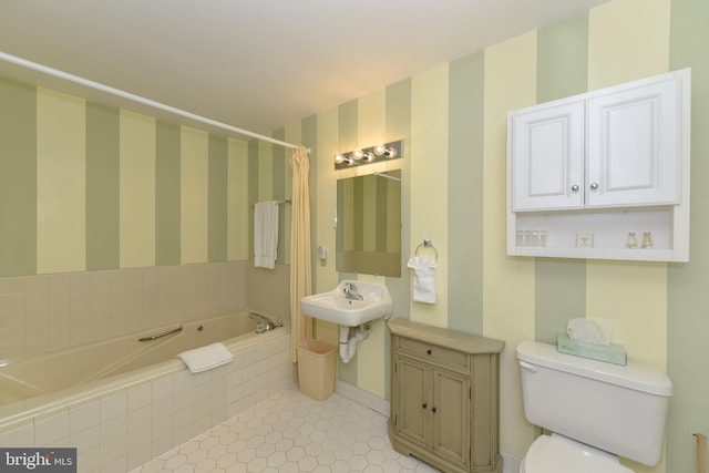 full bathroom with a relaxing tiled tub, toilet, tile patterned flooring, wallpapered walls, and baseboards