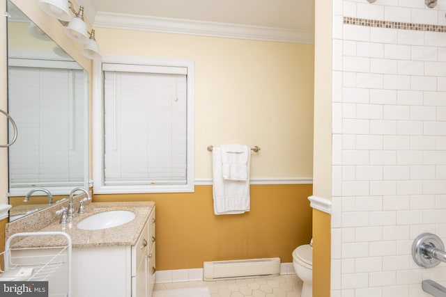 bathroom featuring a baseboard heating unit, crown molding, vanity, toilet, and baseboards