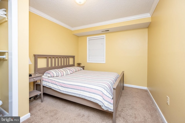 carpeted bedroom with ornamental molding, a textured ceiling, and baseboards