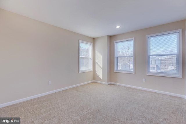 unfurnished room featuring light carpet