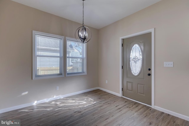 entrance foyer with a notable chandelier and light hardwood / wood-style floors